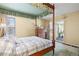 Bedroom with wooden canopy bed, matching wooden dresser and sliding glass door at 2608 E Fremont Pl, Centennial, CO 80122