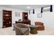 Basement office features dark wood desk, built in shelves, neutral carpet and bright light from window at 2608 E Fremont Pl, Centennial, CO 80122