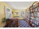 Bright office space with wooden desk, bookshelf, and two windows at 2608 E Fremont Pl, Centennial, CO 80122