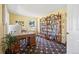 Bright office space featuring a wooden desk, bookshelf, and patterned carpet at 2608 E Fremont Pl, Centennial, CO 80122