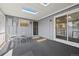 Enclosed patio features skylights, sliding glass doors, an outdoor dining set, and carpeting at 2608 E Fremont Pl, Centennial, CO 80122