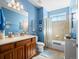 Bathroom featuring a single vanity, decorative mirror, and a tiled shower-over-tub at 19795 W 57Th Ave, Golden, CO 80403
