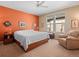 Comfortable bedroom with a ceiling fan, natural light from the windows, and a cozy armchair at 19795 W 57Th Ave, Golden, CO 80403