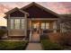 Charming two-story home with red and tan accents and a welcoming front porch entrance under a colorful sky at 19795 W 57Th Ave, Golden, CO 80403