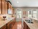 Bright kitchen with granite countertops, wood cabinets, hardwood floors, and a breakfast bar at 19795 W 57Th Ave, Golden, CO 80403