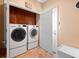 Convenient laundry room with a front loading washer and dryer, and built-in storage at 19795 W 57Th Ave, Golden, CO 80403