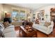 Comfortable living room featuring hardwood floors, windows overlooking the deck, and stylish decor at 19795 W 57Th Ave, Golden, CO 80403