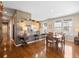 Well-lit living space with hardwood floors, a dining area, and a view into the adjacent kitchen at 19795 W 57Th Ave, Golden, CO 80403