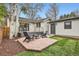 Brick patio features Adirondack chairs, with garage and deck visible at 853 Saint Paul St, Denver, CO 80206