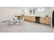 Finished basement with built-in cabinetry, a beverage fridge and an adjacent dining area at 853 Saint Paul St, Denver, CO 80206