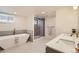 Gorgeous bathroom featuring double sinks, a large soaking tub and stand alone shower at 853 Saint Paul St, Denver, CO 80206