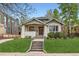 Charming bungalow with inviting front porch and well-manicured lawn at 853 Saint Paul St, Denver, CO 80206