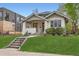 Charming bungalow with inviting front porch and well-manicured lawn at 853 Saint Paul St, Denver, CO 80206