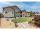 Well-manicured backyard with lush lawn, patio seating, landscaping, and scenic views, creating a serene outdoor oasis at 11890 Discovery Cir, Parker, CO 80138