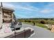 Entertain in this backyard featuring patio seating, a manicured lawn, and scenic views of the open landscape beyond at 11890 Discovery Cir, Parker, CO 80138