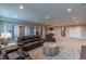 Spacious finished basement features recessed lighting, wet bar, and cozy seating for relaxing or entertaining at 11890 Discovery Cir, Parker, CO 80138