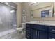 Modern bathroom featuring a glass enclosed shower, brushed nickel faucet, and a navy blue vanity at 11890 Discovery Cir, Parker, CO 80138
