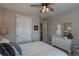 Well-lit bedroom with a large window, ceiling fan, and white dresser at 11890 Discovery Cir, Parker, CO 80138