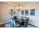 Formal dining room features a dark wood table and six chairs, illuminated by a chandelier at 11890 Discovery Cir, Parker, CO 80138