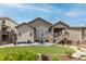 Rear exterior showcasing a patio, deck, manicured lawn, and beautiful landscaping, perfect for outdoor living and entertaining at 11890 Discovery Cir, Parker, CO 80138