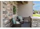 Inviting front porch featuring stone accents, comfortable seating, and a decorative wreath, perfect for relaxing outdoors at 11890 Discovery Cir, Parker, CO 80138
