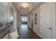 Inviting hallway with wood floors, tray ceilings, elegant decor, and an open view into the living space, exuding modern elegance at 11890 Discovery Cir, Parker, CO 80138