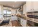 Modern kitchen features stainless steel appliances, white cabinets, and a stylish backsplash and granite countertop at 11890 Discovery Cir, Parker, CO 80138