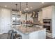 Beautiful kitchen island with pendant lighting, stainless steel appliances and granite countertops with barstool seating at 11890 Discovery Cir, Parker, CO 80138