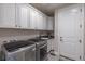 Functional laundry room equipped with modern appliances and ample cabinet storage at 11890 Discovery Cir, Parker, CO 80138