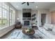 Comfortable living room featuring a stone fireplace, large windows, and an inviting sitting area at 11890 Discovery Cir, Parker, CO 80138
