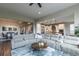 Spacious living room with a large sectional sofa, open to the kitchen and dining areas at 11890 Discovery Cir, Parker, CO 80138
