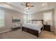 Tranquil main bedroom with natural light, neutral tones, and a tray ceiling at 11890 Discovery Cir, Parker, CO 80138