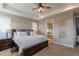 Serene main bedroom featuring tray ceilings, plantation shutters, and an ensuite bathroom at 11890 Discovery Cir, Parker, CO 80138