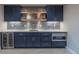 Basement wet bar featuring dark cabinets, beverage fridge, microwave, and tile backsplash at 11890 Discovery Cir, Parker, CO 80138