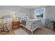 Cozy bedroom with a bed and a side table bathed in natural light from the window at 4530 Ridgewood Ct, Castle Rock, CO 80109