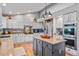 Modern kitchen with stainless appliances, light cabinetry, and a gray kitchen island at 4530 Ridgewood Ct, Castle Rock, CO 80109