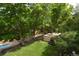Lush backyard features a sparkling swimming pool, mature trees, a grassy lawn, and garden area at 8130 E Bethany Pl, Denver, CO 80231