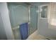 This bathroom features blue tile and a shower with sliding glass doors at 8130 E Bethany Pl, Denver, CO 80231