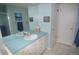 This bathroom features a blue vanity with a mirror and a shower at 8130 E Bethany Pl, Denver, CO 80231