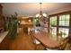 A dining room adjoins the kitchen and features wood floors and a chandelier at 8130 E Bethany Pl, Denver, CO 80231