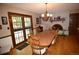 Dining area with hardwood floors, a brick fireplace, and glass doors leading to the outside at 8130 E Bethany Pl, Denver, CO 80231