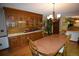 Classic dining room with hardwood floors, wood table, and a built-in hutch with glass doors for displaying china at 8130 E Bethany Pl, Denver, CO 80231