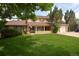 Charming two-story home with a well-manicured lawn and covered porch at 8130 E Bethany Pl, Denver, CO 80231