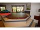 This room features a large hot tub with steps and several windows at 8130 E Bethany Pl, Denver, CO 80231