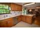 The kitchen has wood cabinets, a white countertop, and stainless steel dishwasher at 8130 E Bethany Pl, Denver, CO 80231