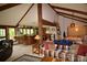 Open-concept living space with bar, vaulted ceilings, and a comfortable seating area at 8130 E Bethany Pl, Denver, CO 80231