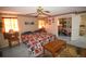 Warm and inviting bedroom with a ceiling fan, natural lighting, and mirrored closet doors at 8130 E Bethany Pl, Denver, CO 80231
