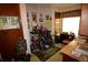 Cozy office space featuring a desk, a bicycle, and lots of photos on the wall at 8130 E Bethany Pl, Denver, CO 80231