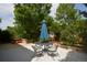 A view of the backyard patio showing a dining table set and umbrella at 8130 E Bethany Pl, Denver, CO 80231