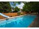 A beautiful pool with a slide with a wooden fence around the pool in the backyard at 8130 E Bethany Pl, Denver, CO 80231